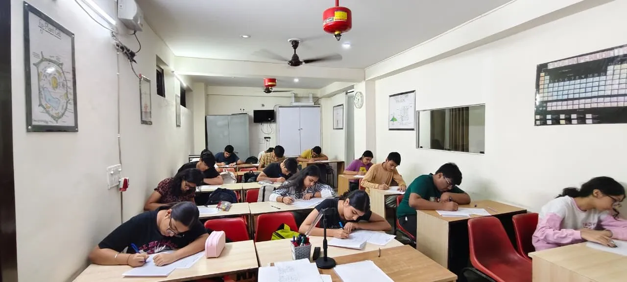 A classroom seen end to end, students working at their desks.