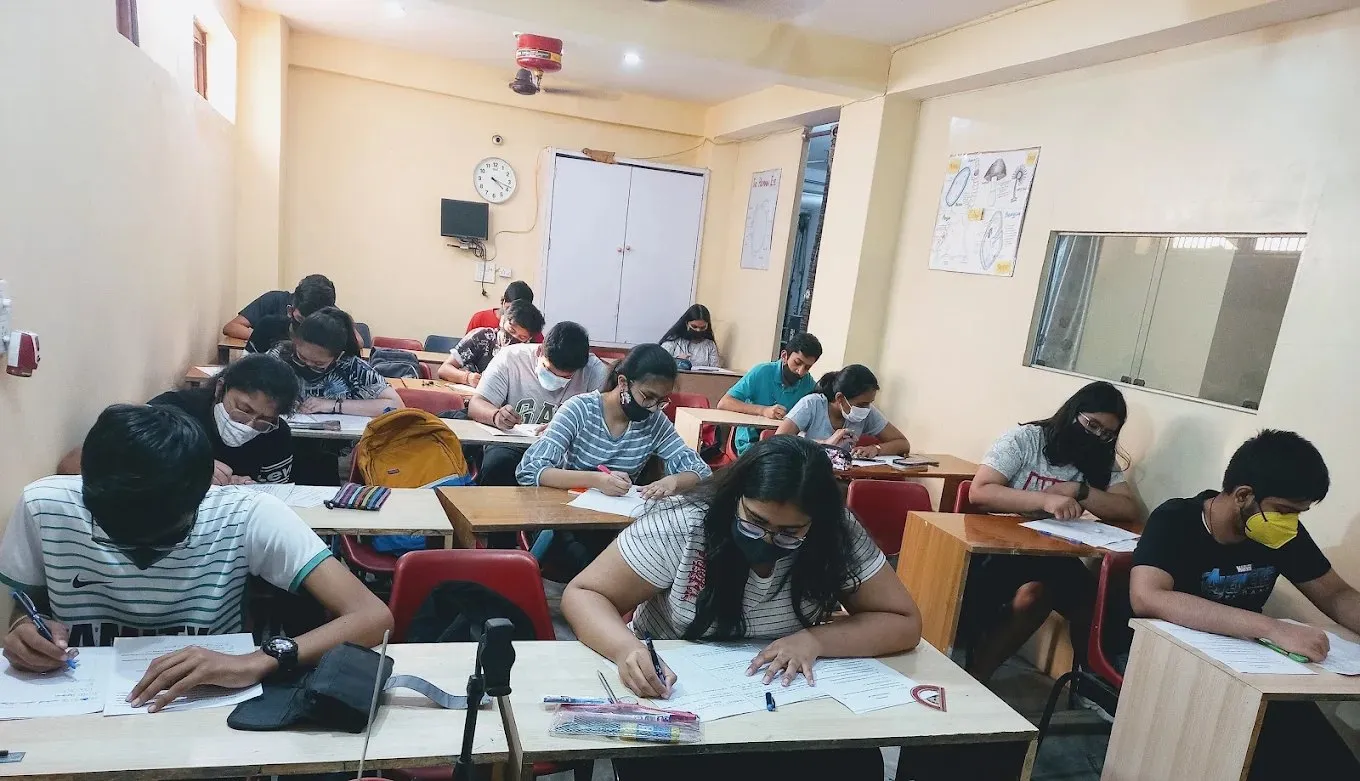 A classroom photographed from the side, students working at their desks.
