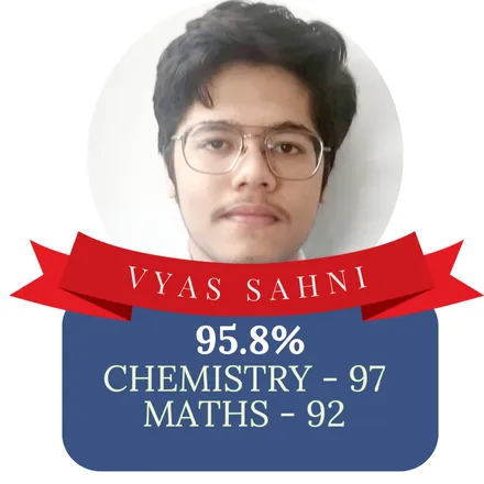 A Class XII stream topper at I Quest Classes, with their stream and marks printed on the card.