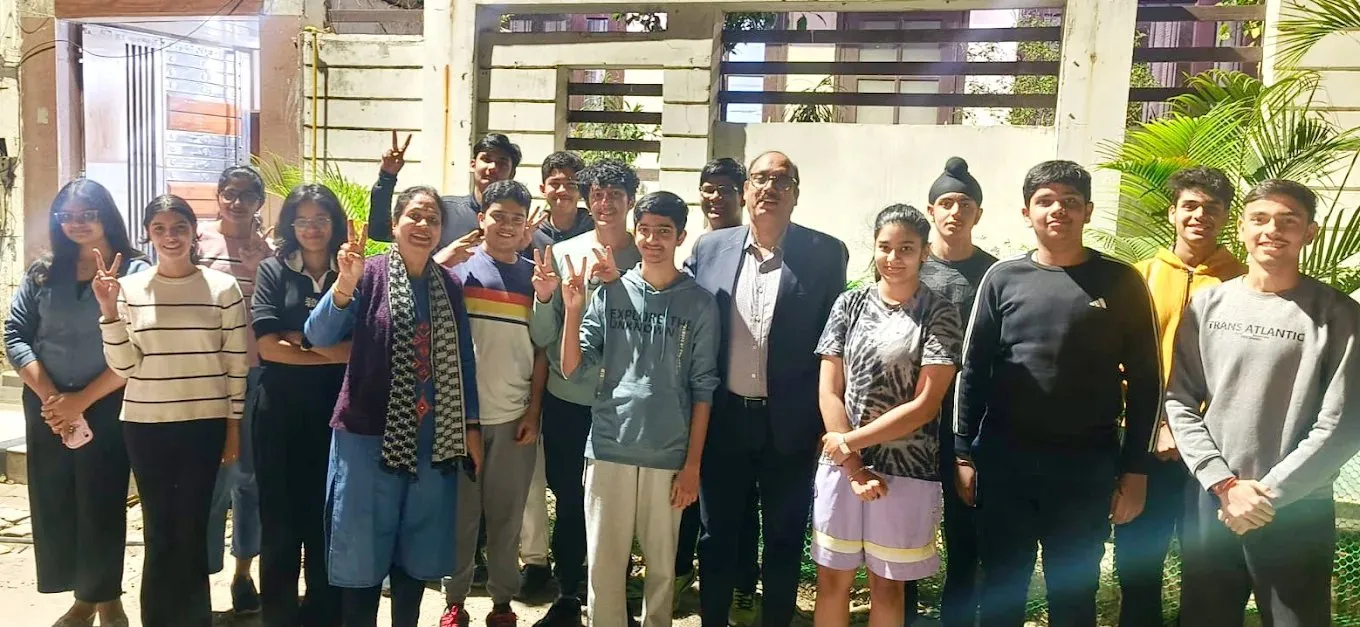 Students photographed outdoors with the two people who run I Quest Classes.